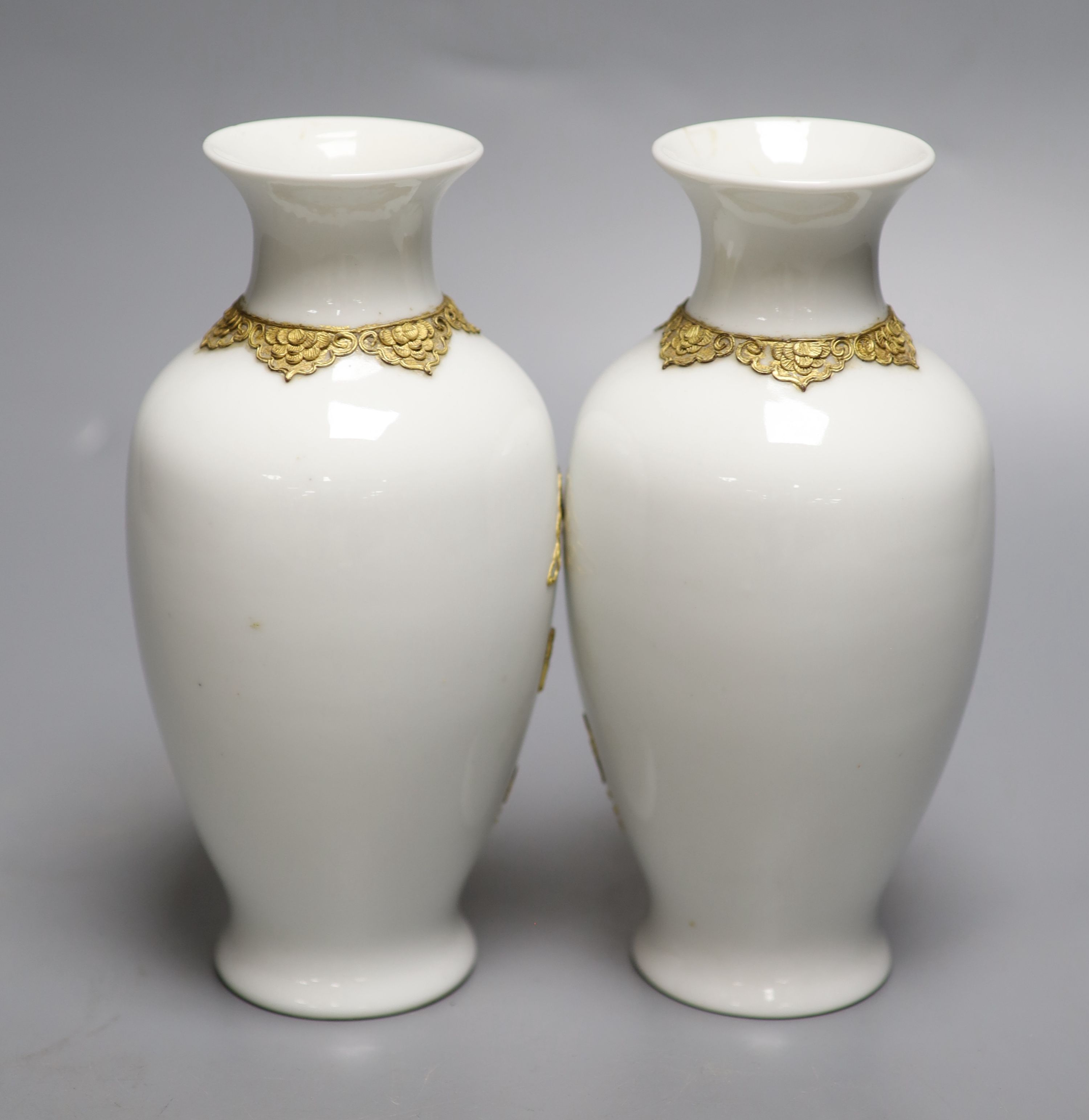 A pair of Chinese blanc de chine vases encrusted with gilt dragons, height 18cm